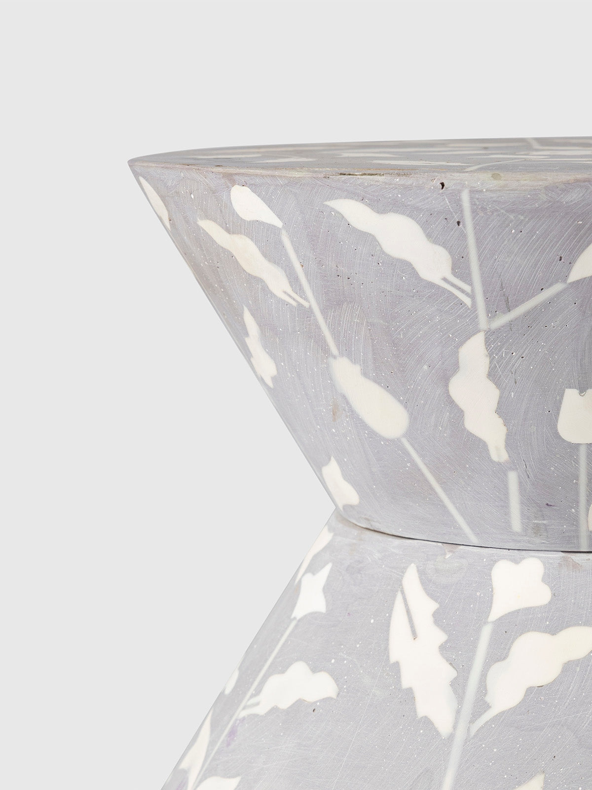 Close-up of the Heritage Inlay Floral Round End Table showing intricate bone inlay design on a soft grey surface.