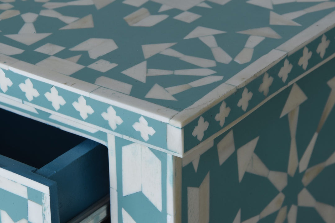 Heritage Inlay Moroccan Pattern Console Table with intricate geometric bone inlay design on a smooth blue surface.